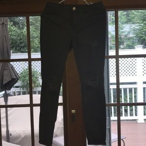 Hunter green jeans with ripped knees